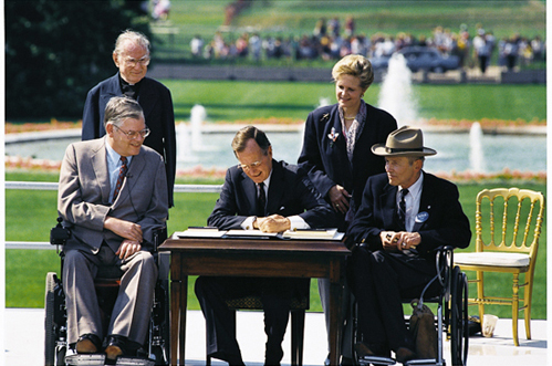 President George H.W. Bush signs the Americans with Disabilities Act in 1990.